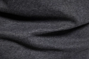 Macro detail of breathable dark gray knitted fabric showing smooth texture and soft fibers