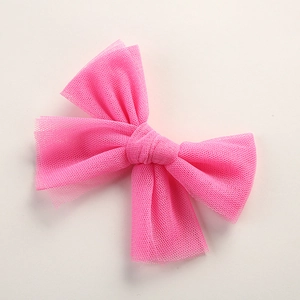 Detail shot of a bright pink mesh butterfly hair clip on a clean white background