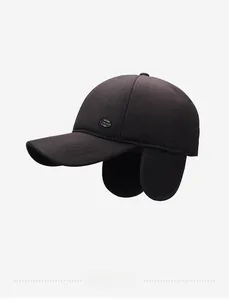 Detailed side view of winter wool baseball cap with ear protection and metal shield badge