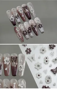 Detailed view of 5D 3D butterfly nail charms and floral patterns on adhesive nail stickers