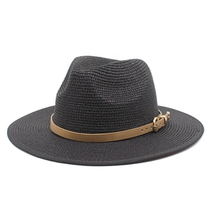 Detail of black woven straw Fedora hat featuring a brown leather band and gold metal buckle