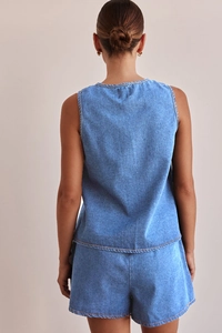Rear view of light blue denim two-piece set featuring sleeveless top and high waist shorts