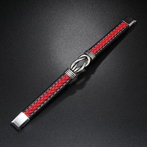 Detail of red and black braided leather bracelet with metal knot and magnetic buckle
