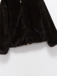 Detailed view of the dark faux fur hem texture on a stylish bomber jacket for women