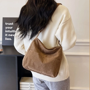 Brown corduroy crossbody bag with adjustable strap and front pocket for women