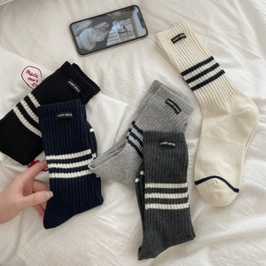 Five-pack set of ribbed cotton mid-calf socks with white stripes and label in neutral tones