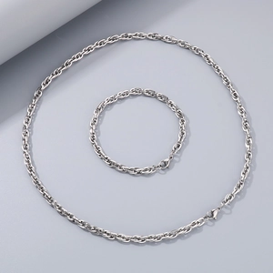 Detailed view of silver braided rope chain necklace and bracelet jewelry set with lobster clasps