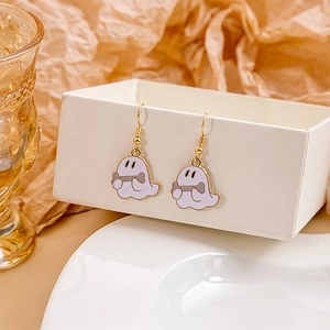 Detail view of cute white ghost earrings with grey bone charms and golden metal hooks