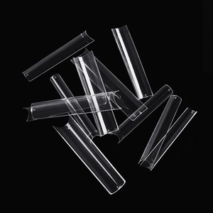 Macro detail of transparent XXL square nail tips showing size numbers on black surface