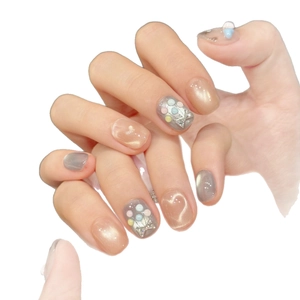 Cat eye press-on nails with blue magnetic polish and 3D macaron bead decorations