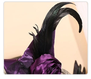 Detail of purple satin witch hat with rose flower, feathers and black lace mesh