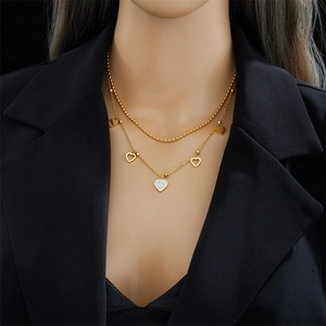 Double-layered gold heart necklace featuring beaded chains and zircon-studded heart pendants