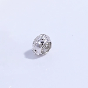Detailed close-up of S925 sterling silver hollow barrel bead with clear zircon crystals