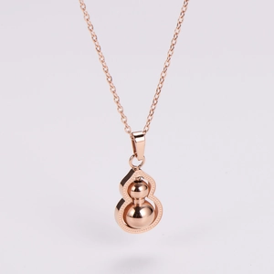 Detailed view of rose gold gourd pendant necklace with hollow frame and metal spheres