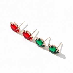 Detail of water drop zircon stud earrings in red and green with 14k gold plating