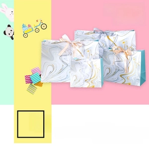 Detailed view of marble pattern gift bags with ribbon bows in various sizes and styles