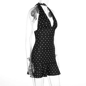 Detail of ruffled hem and polka dot print on a black halter neck summer dress