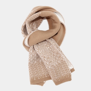 Detailed view of camel and white knit scarf with a textured jacquard dot pattern