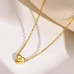 Detailed close-up of a gold stainless steel heart pendant with engraved letter D
