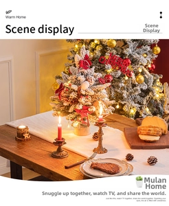 Close-up of white plush table runner with mini lit Christmas tree and red ribbon
