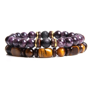 Detail of beaded bracelet set with tiger eye stones, lava rock beads, and purple accents