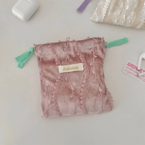 Detail of pink velvet drawstring pouch with lace trim and mint green cord for small items