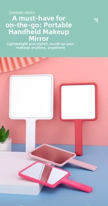 Detail of square handheld cosmetic mirrors in white, red, and pink with ergonomic handle