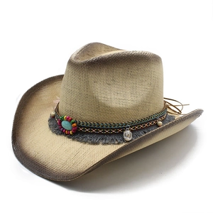 Detail of cowboy straw hat with turquoise beads, tassels, and coin pendant decoration