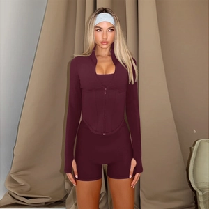 Women's deep red zip-up long sleeve top and tight peach lift shorts yoga set