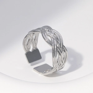 Close-up of adjustable silver woven mesh metal ring on a white display stand