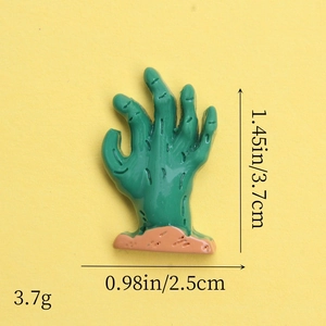 Macro view of green resin zombie hand charm with size dimensions 3.7cm by 2.5cm