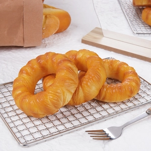 Realistic slow-rebound PU donut bread model on cooling rack for stress relief play