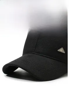 Detail of sturdy black baseball cap brim with metallic logo and textured wool fabric