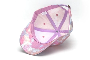 Detailed inner view of a colorful tie-dye children's baseball cap with care label.