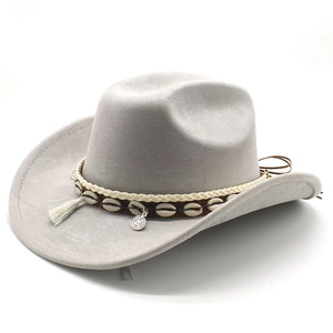 Close-up of white fringe tassels and shell accents on a grey suede cowboy hat