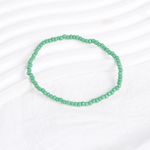Close-up of mint green seed bead bracelet showing uniform round beads and smooth texture