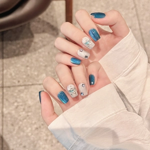 Handmade Klein blue cat eye press-on nails with silver stars and rhinestone accents