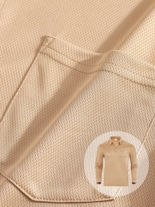 Close-up of khaki breathable mesh fabric texture and pocket stitching on men's polo shirt