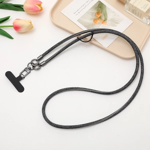 Detail of dark gray woven phone lanyard with metal clasp and black tether tab shown on desk