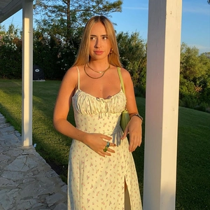 Detail of floral spaghetti strap dress with side slit and ruched bodice detail