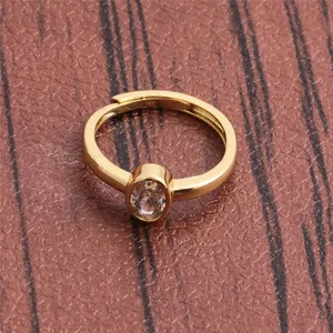 Detail view of gold-plated adjustable ring featuring a single oval cubic zirconia stone