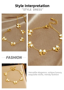 Detail of 18K gold chain bracelet featuring white butterfly charms on silk background