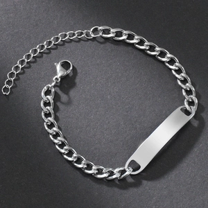 Detail of silver stainless steel Cuban link bracelet with engravable blank bar and lobster clasp