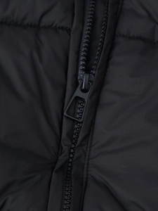 Macro view of a durable black metal zipper on premium quilted puffer jacket fabric