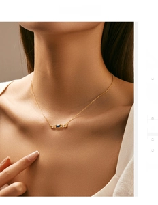 Detail of s925 sterling silver necklace featuring an emerald-cut blue gemstone pendant