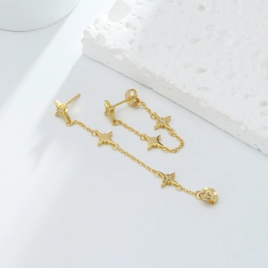 Detailed view of asymmetric S925 sterling silver star fringe earrings with gold finish