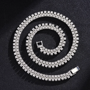 Double row silver tennis chain necklace with clear rhinestones on black background