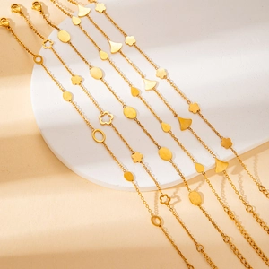 Minimalist gold-plated stainless steel bracelet with diverse charms on a stone base