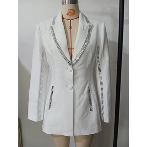 Detail of silver rhinestones on lapels and cuffs of a white slim-fit tailored blazer