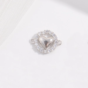 Vue macro du connecteur cœur en argent avec zircons et deux anneaux pour création de bijoux